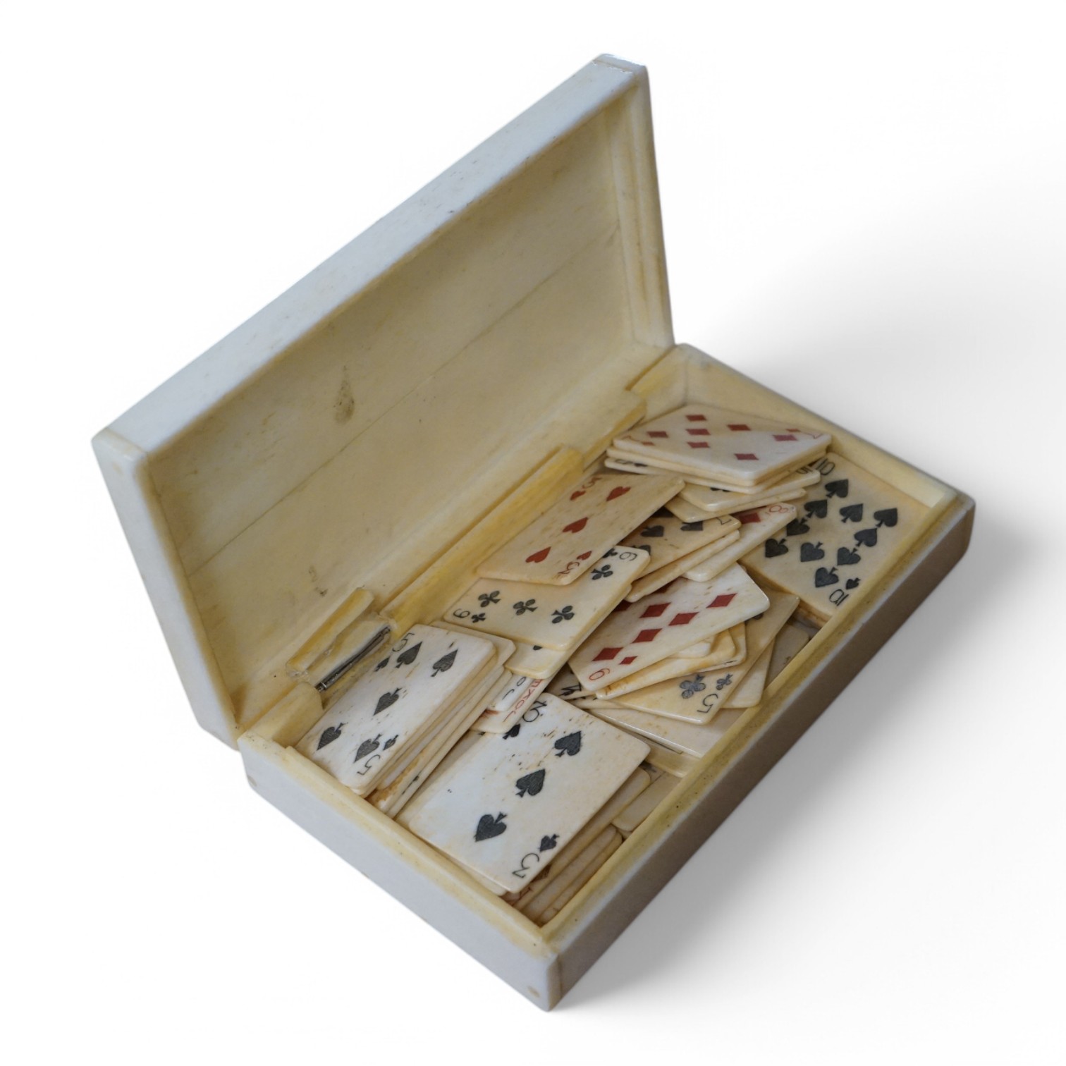 A scrimshaw carved bone miniature playing card set, 10.5cm wide. Condition - fair/good